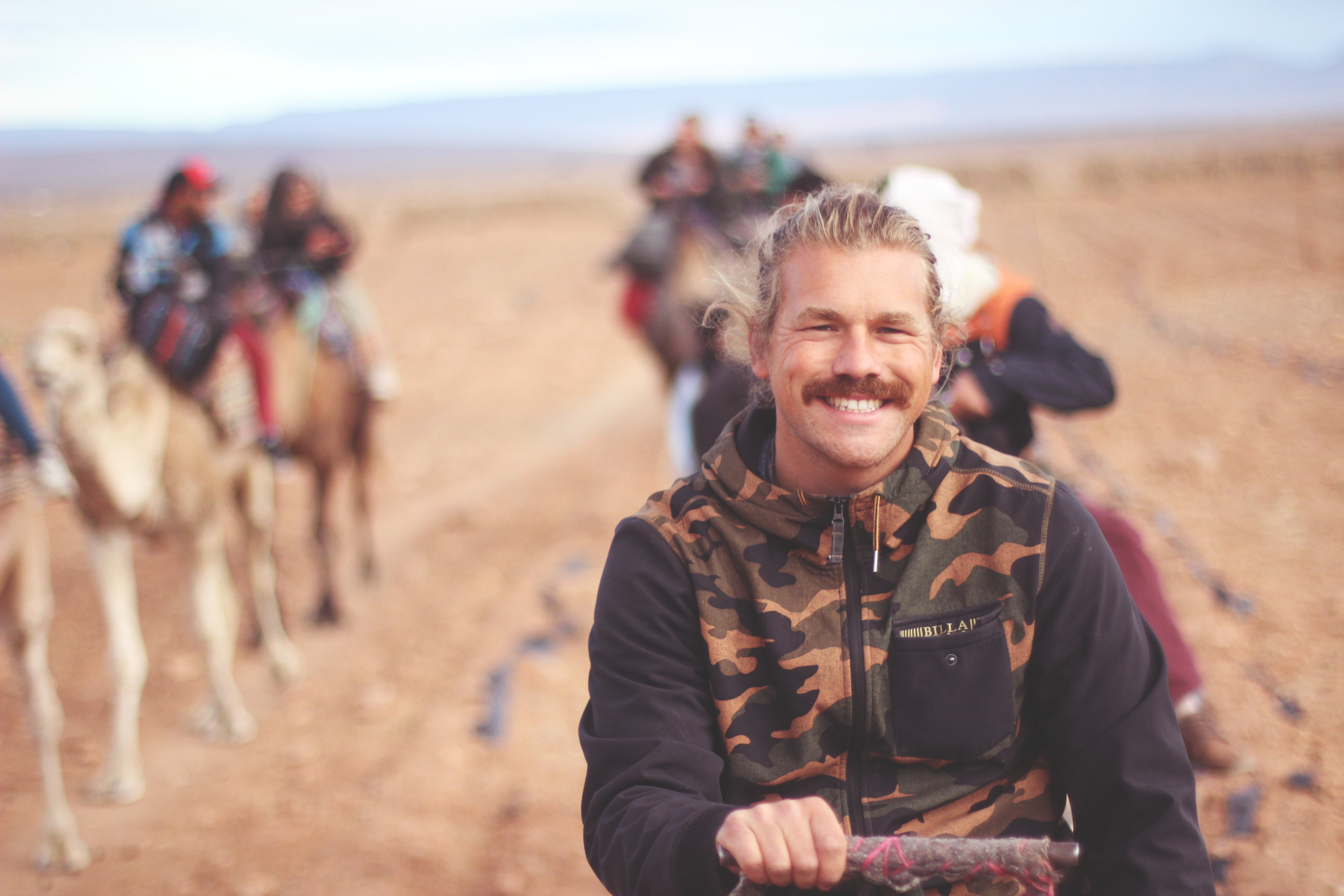 camel riding in the desert on surf instructor course